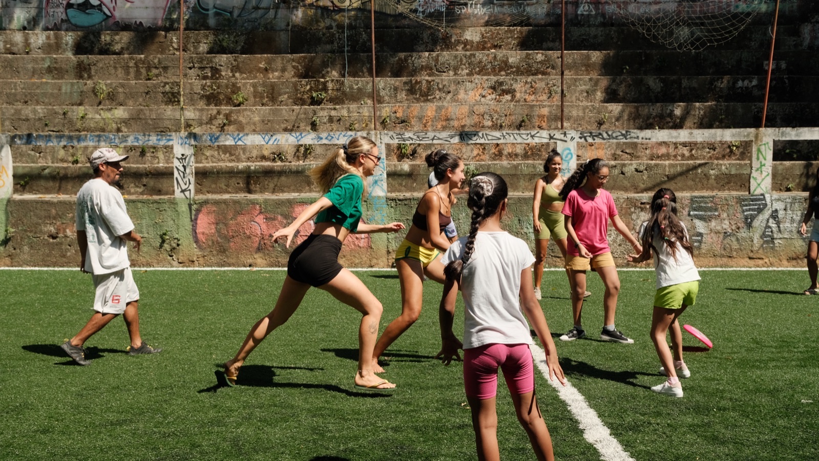 Children run across the artificial pitch during an after-school game.