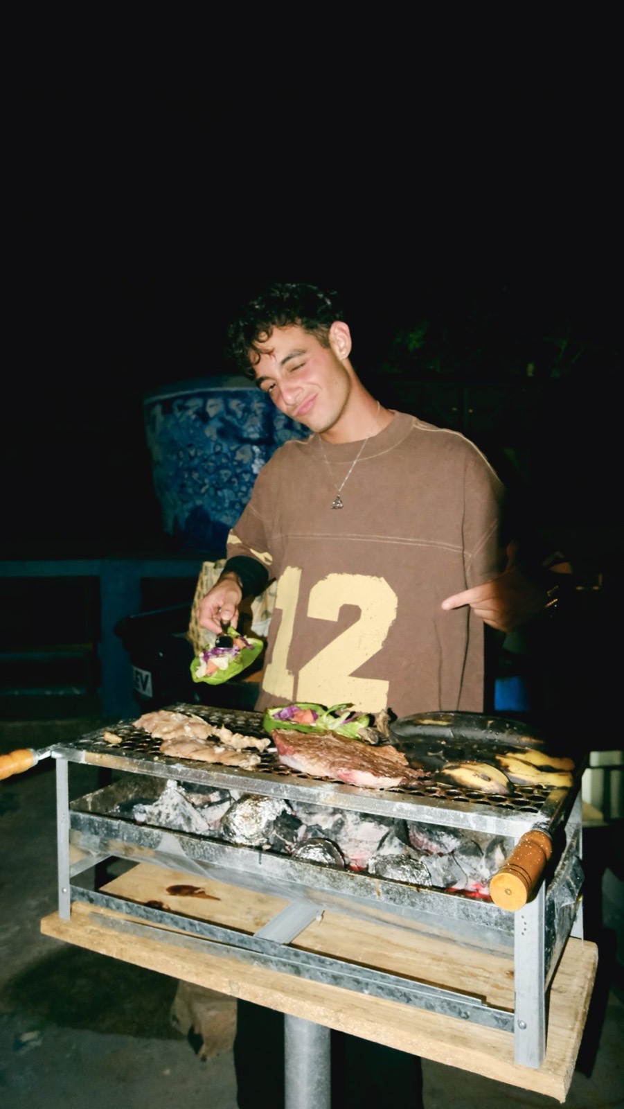 A volunteer grilling meat at a churrasco night.